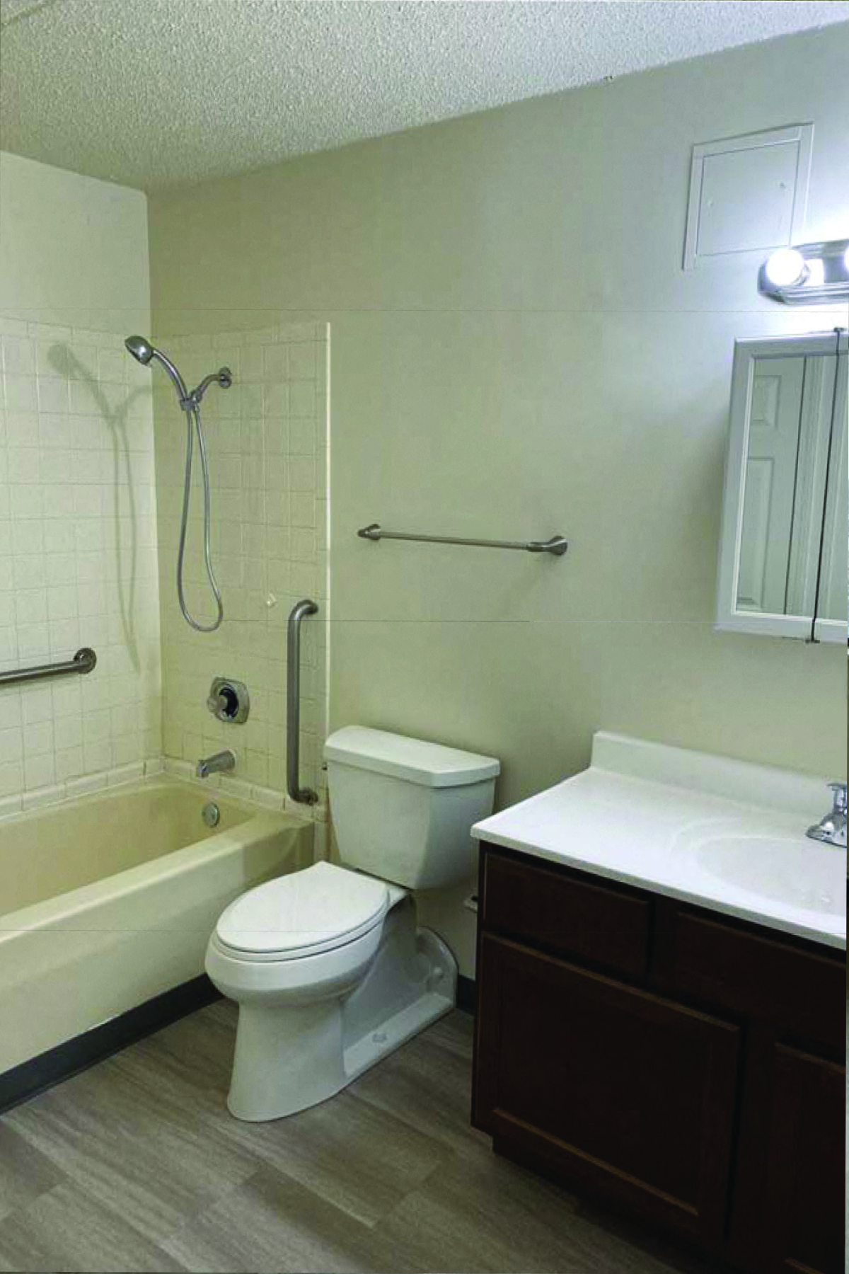 a bathroom with a toilet and a tub and a sink